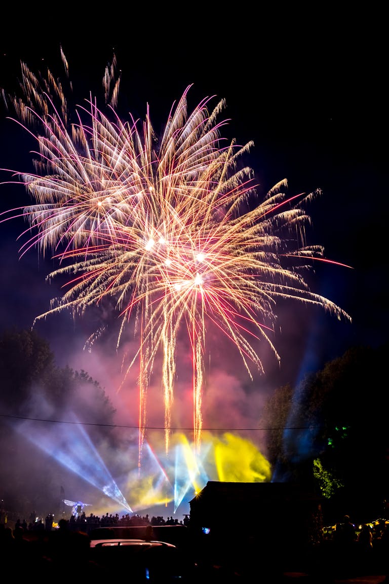Spectacular fireworks illuminating the night sky at a festival celebration.