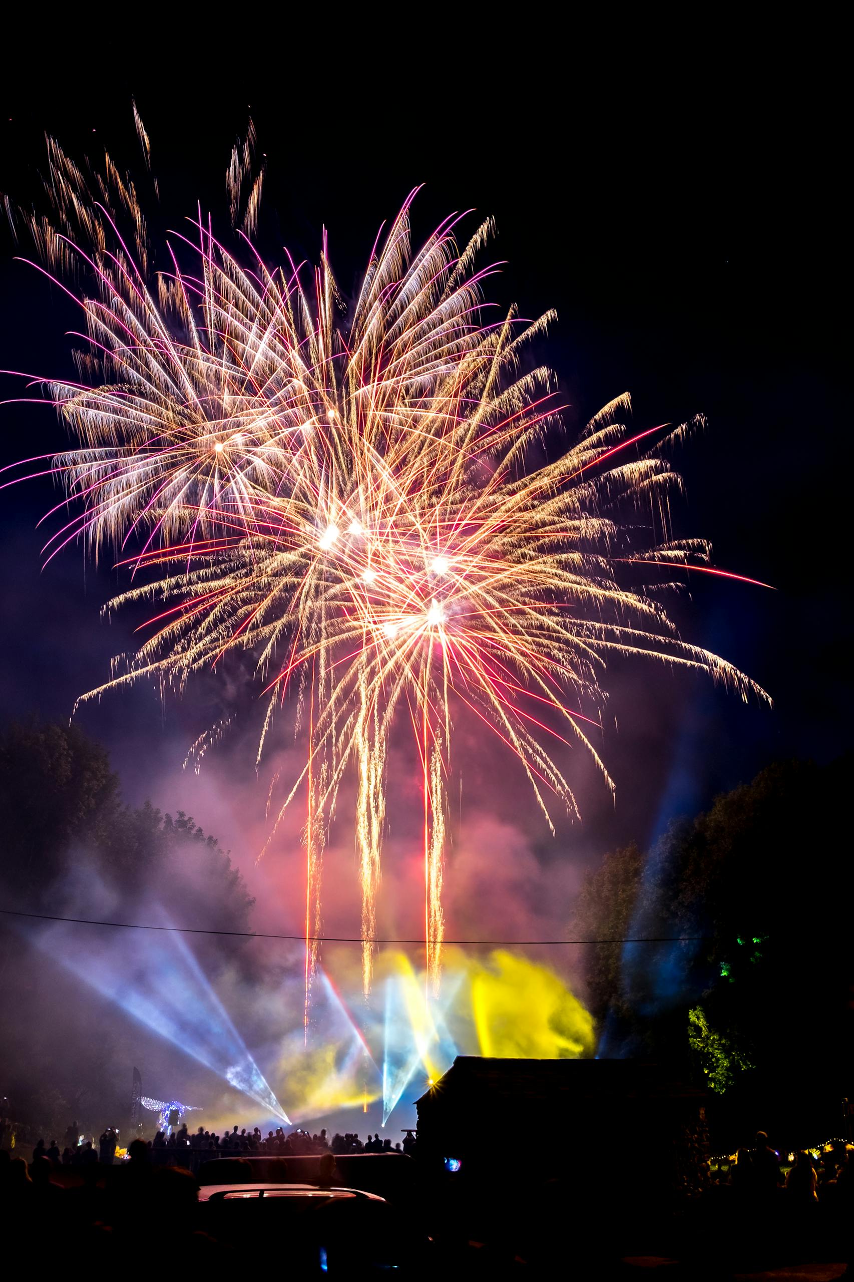 Spectacular fireworks illuminating the night sky at a festival celebration.